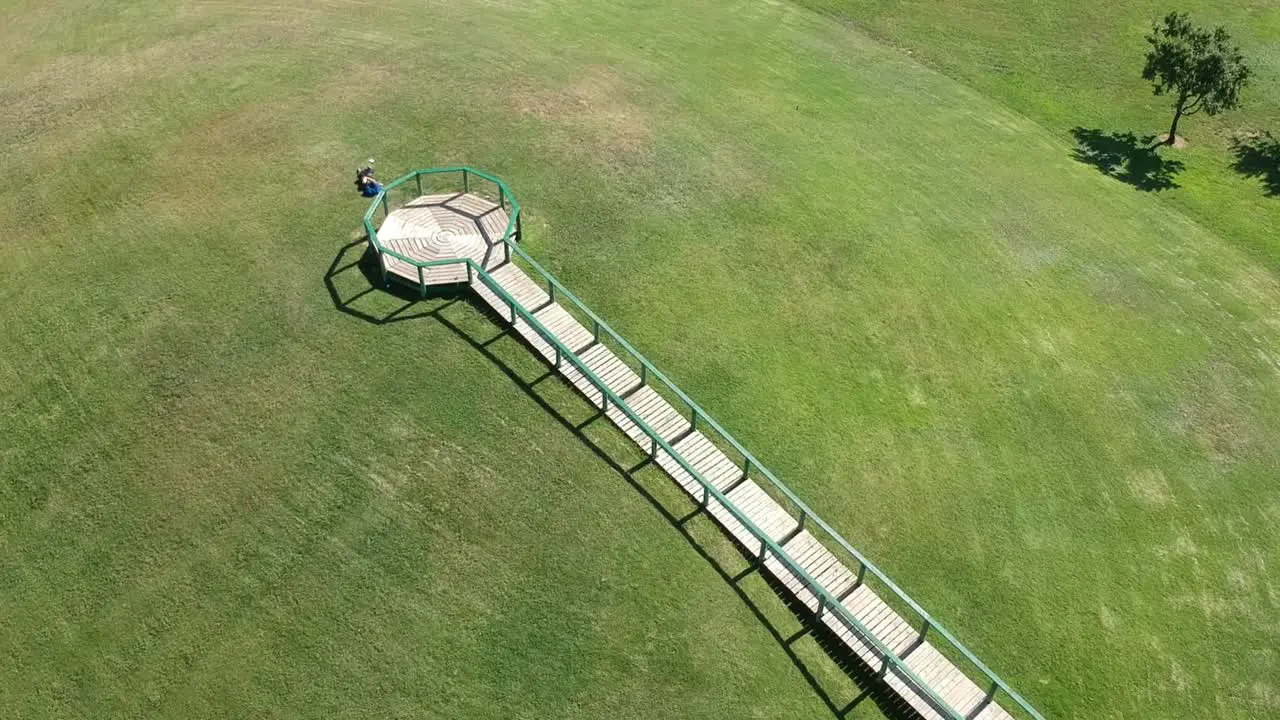 Wooden walkway in a green meadow park