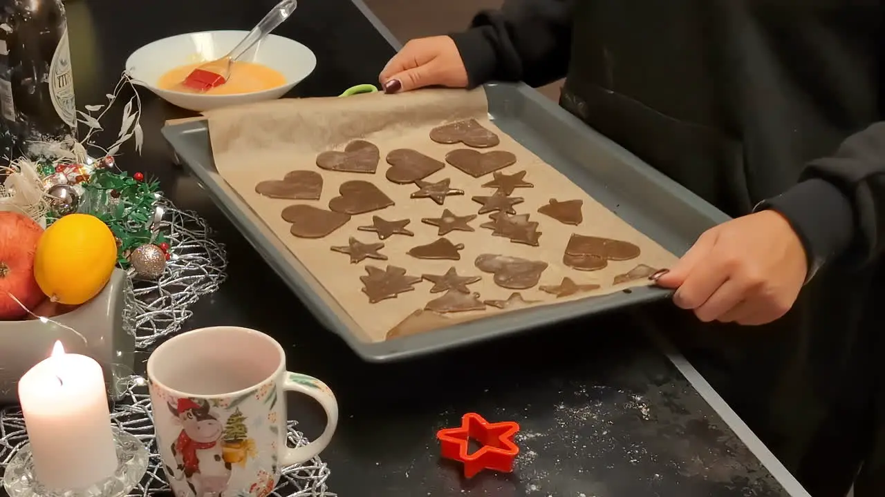 Women up close taking gingerbread shapes homemade cookie for baking