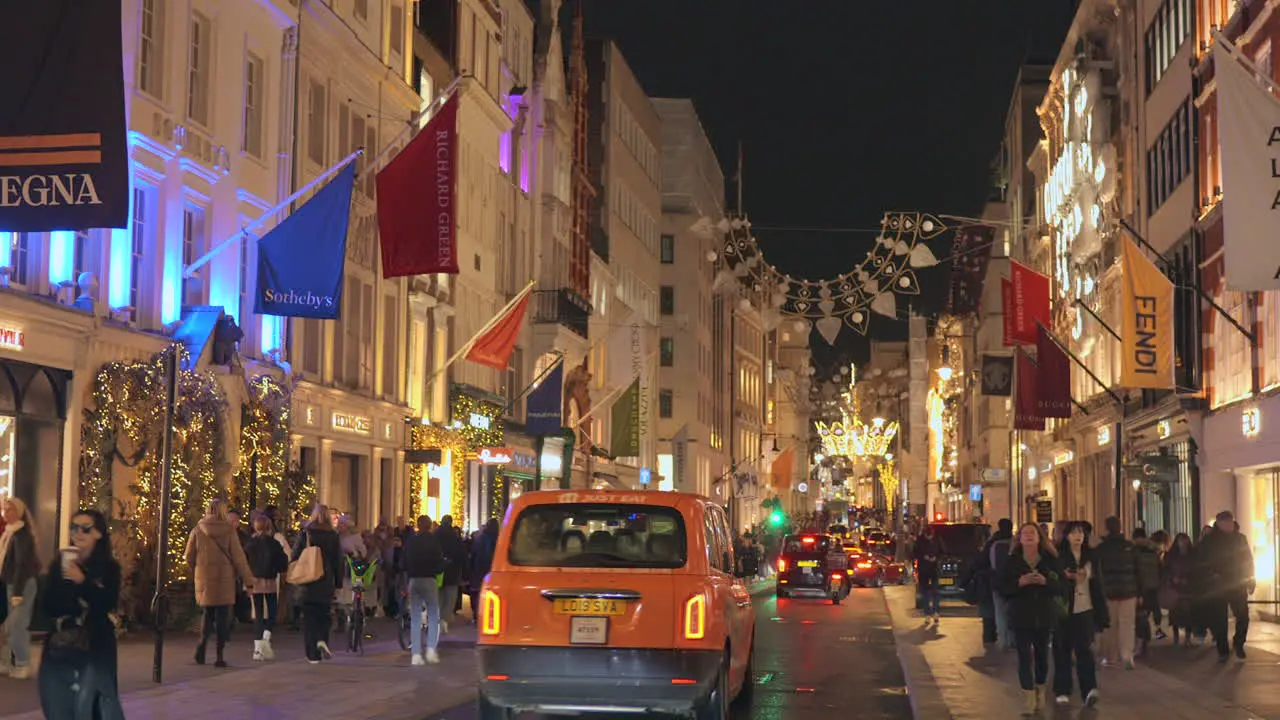 Large number of people walking along the street during Christmas time in London England