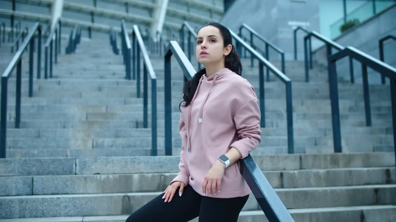 Fitness woman relaxing on staircase outdoor Young female model posing on stairs