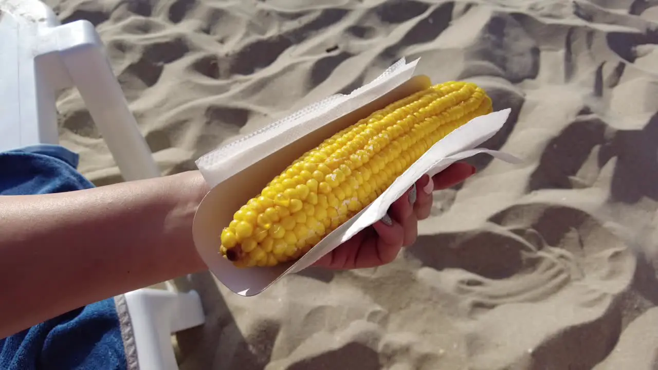 Holding Sweet Corn on the Beach