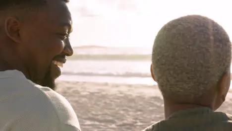 Black couple love and laugh at a beach