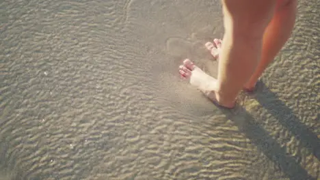 Woman beach and relax with feet in water