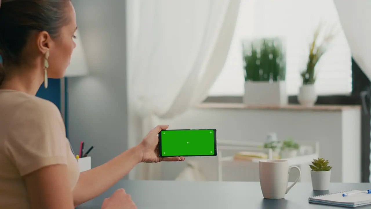 Business woman holding phone with mock up green screen chroma