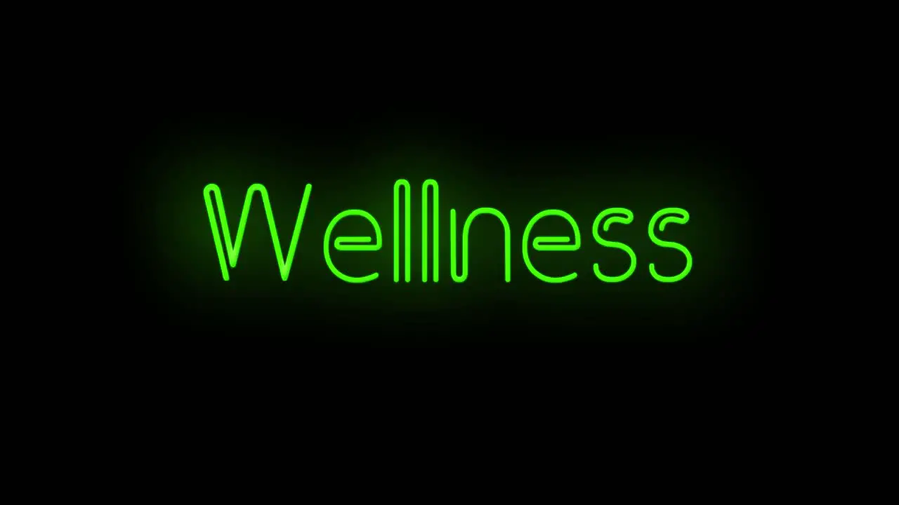 Flashing neon green Wellness sign on black background on and off with flicker