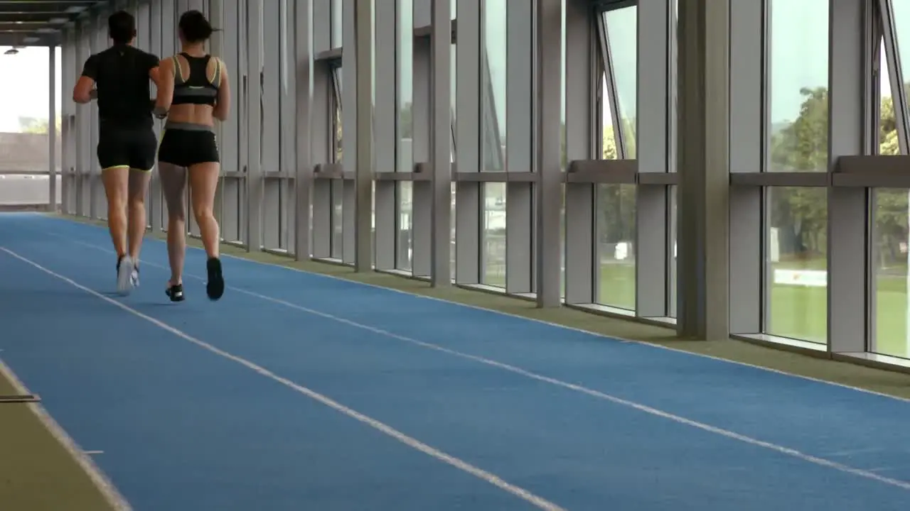 Couple jogging on indoor track