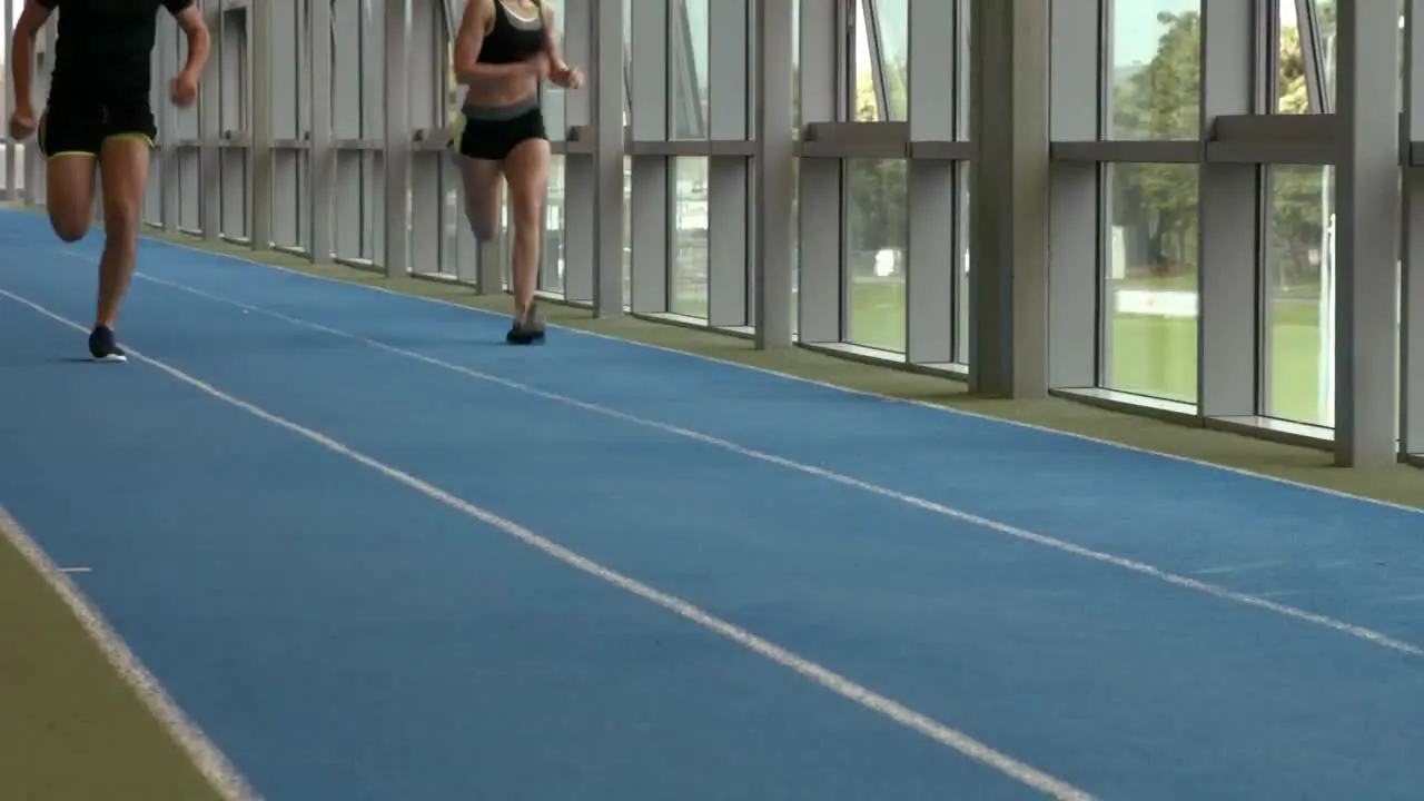 Couple racing on indoor track