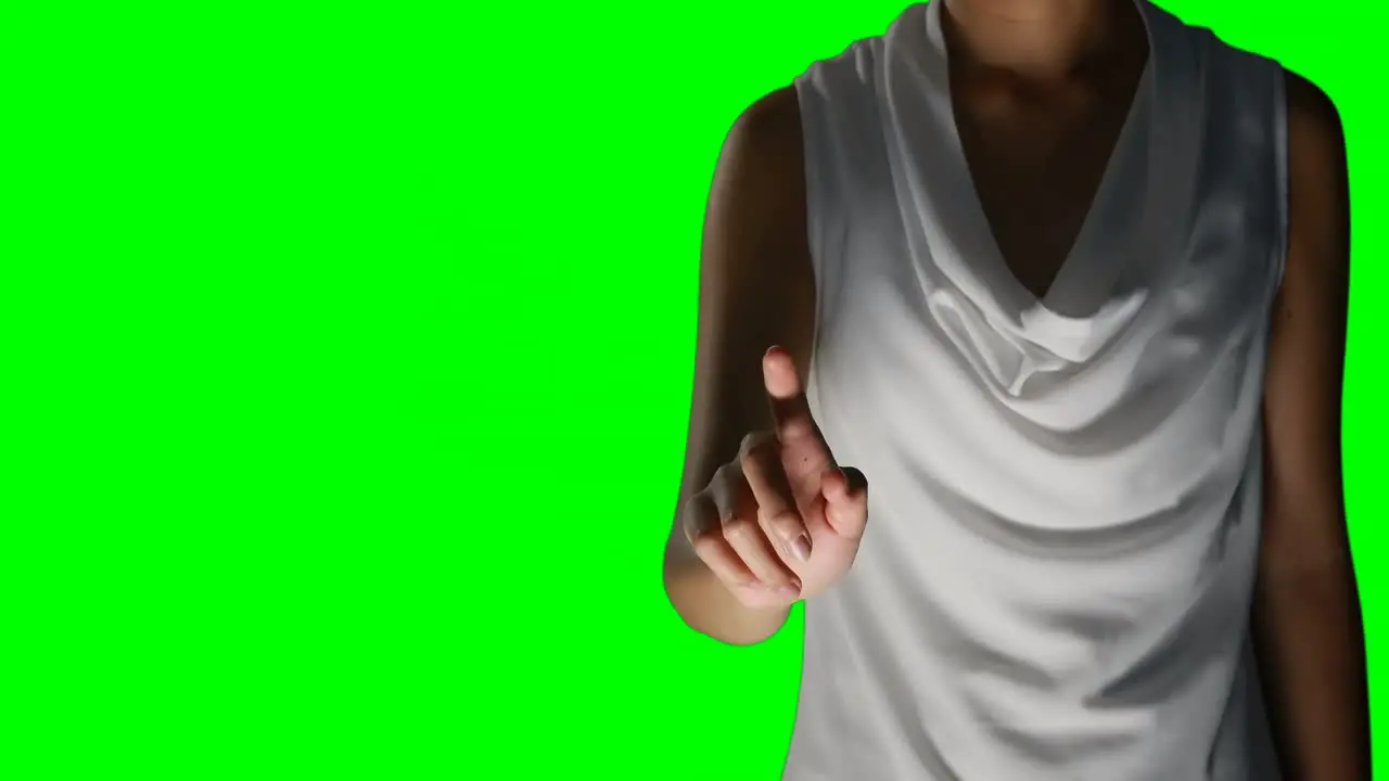 Woman touching invisible against green screen background