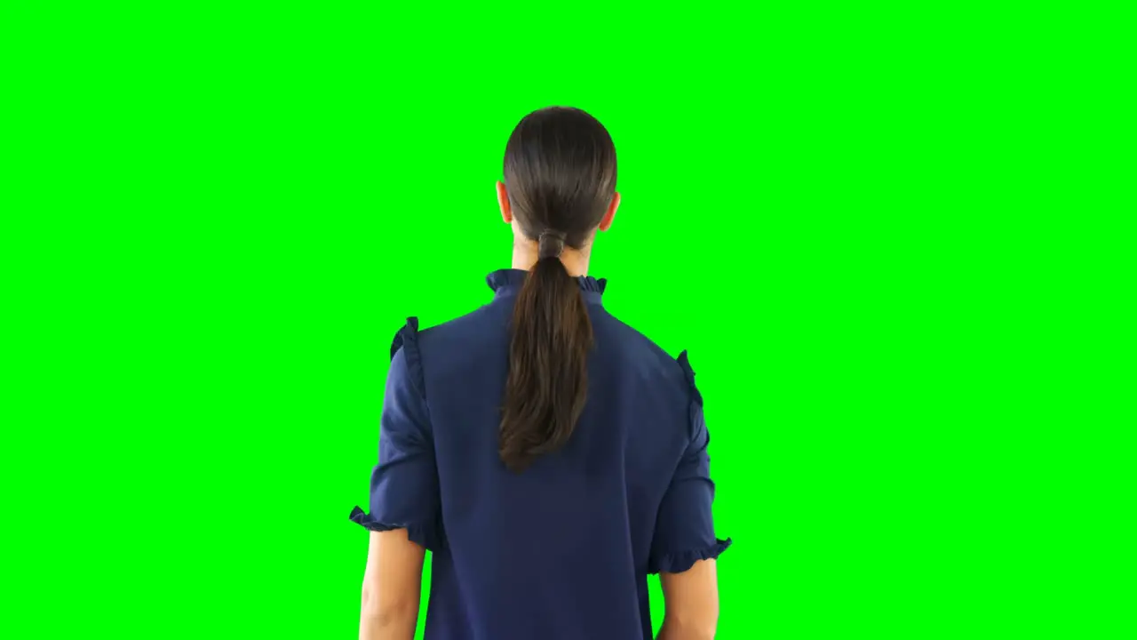 Woman looking at invisible screen against green screen 4k