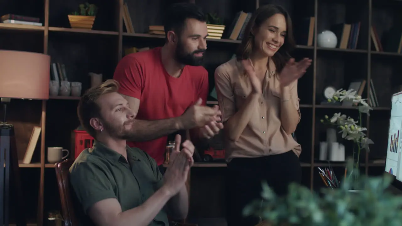 Business team clapping hand in office Successful workers enjoy statistic data