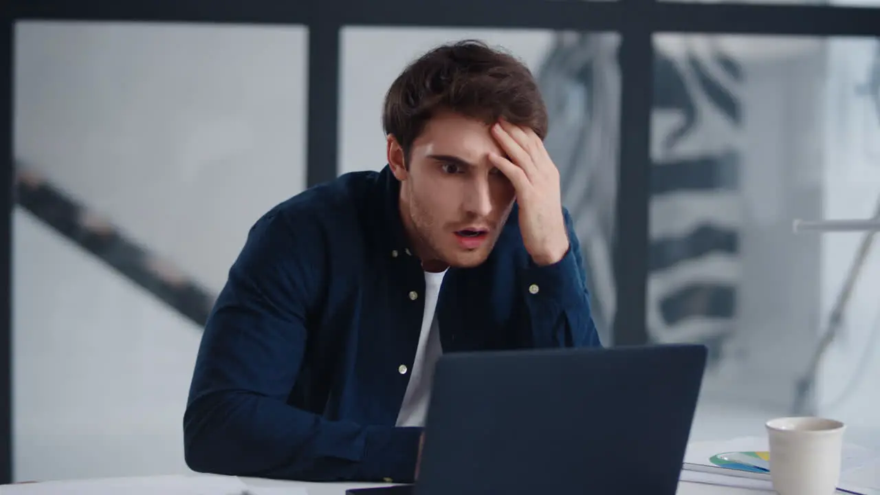 Closeup shocked business man looking computer screen in office