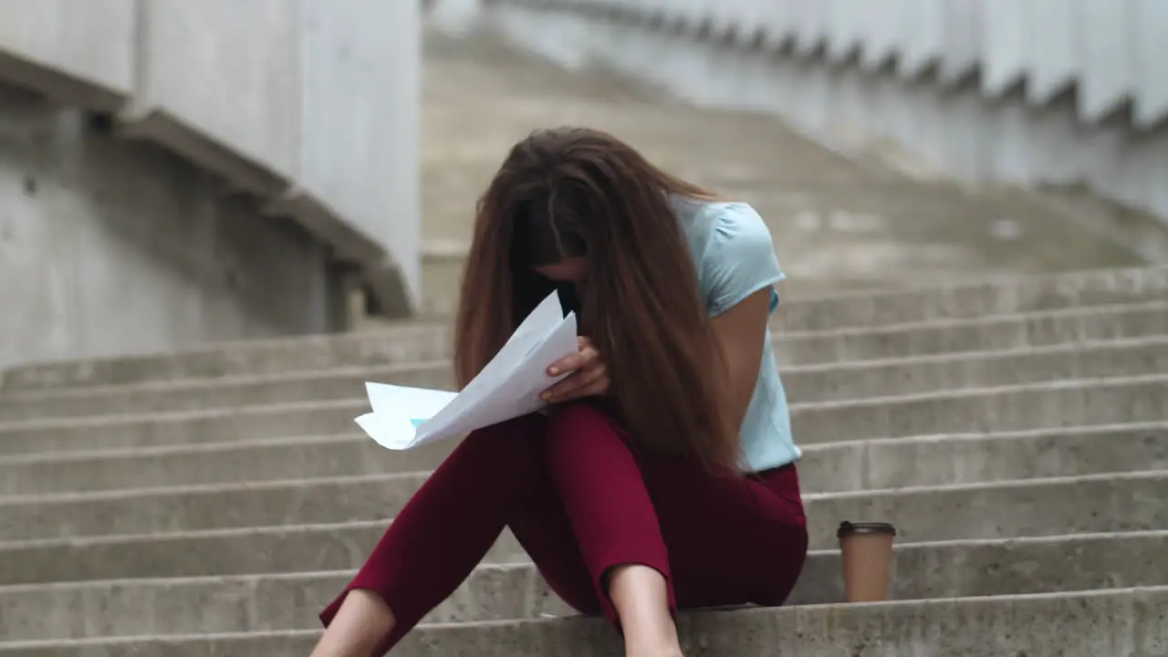 Businesswoman looking at bad financial statistics Manager sitting on stairs