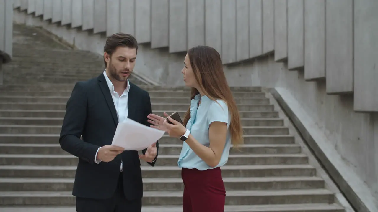 Woman yelling on man on street Colleagues arguing about bad work results