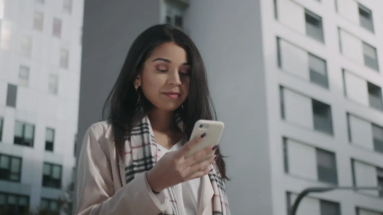 Businesswoman using smartphone on street Female professional texting on phone