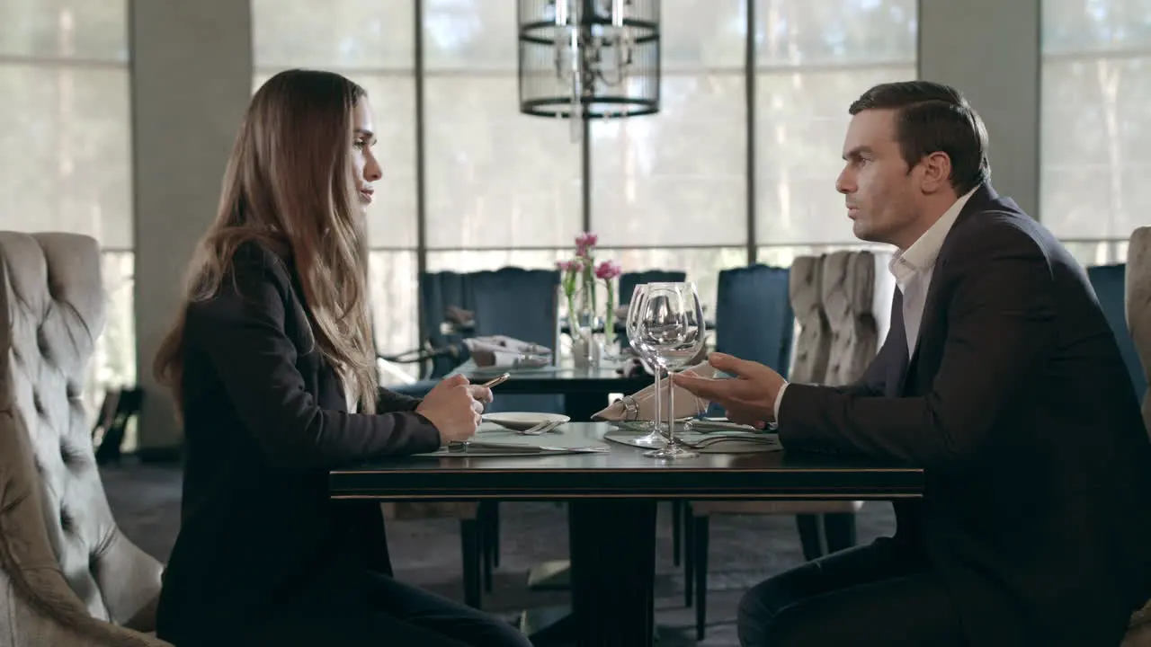 Business man and woman talking in restaurant Businessman and businesswoman