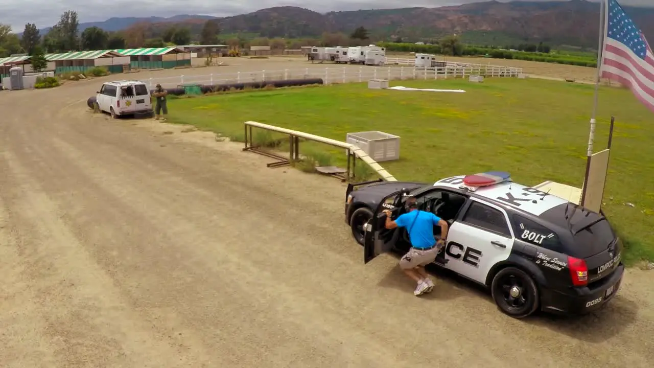 Aerial view above a K9 dog in training in a mock shootout between police and criminals