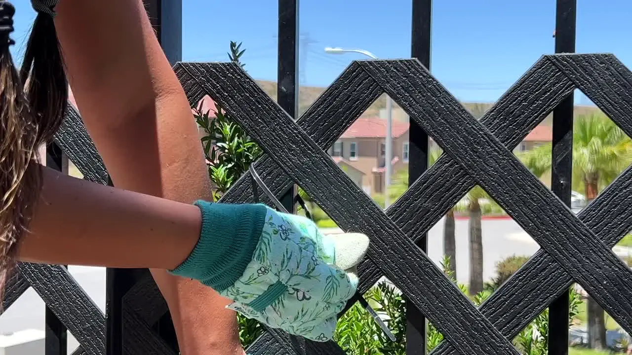 Up close view of handy Hispanic female fixing fence real life people home repair