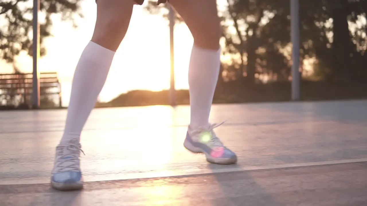 Close Up Of Female Basketball Player Legs In White Golf Socks Doing Dribbling Exersice Very Quickly Run Backwards Training Outdoors On The Local Court 1