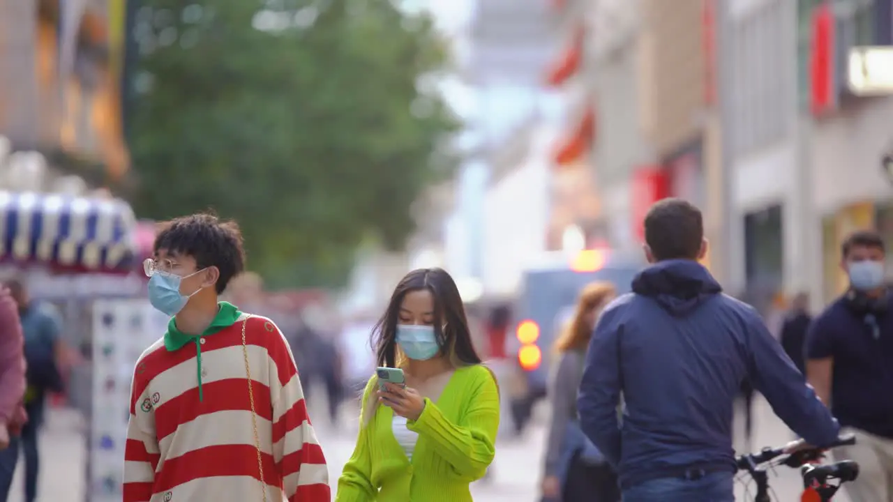 Asian couple wearing a face mask in downtown Munich