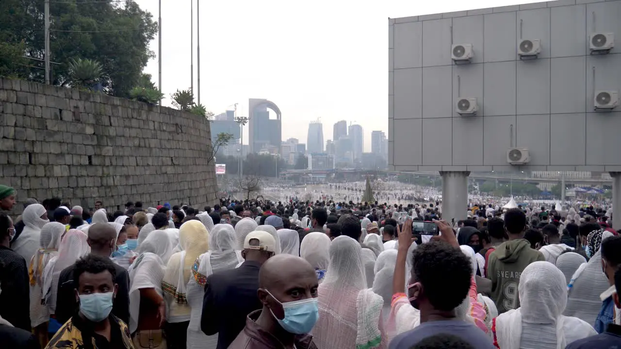 people are entering the stadium area to watch the festival of burning the bonfire