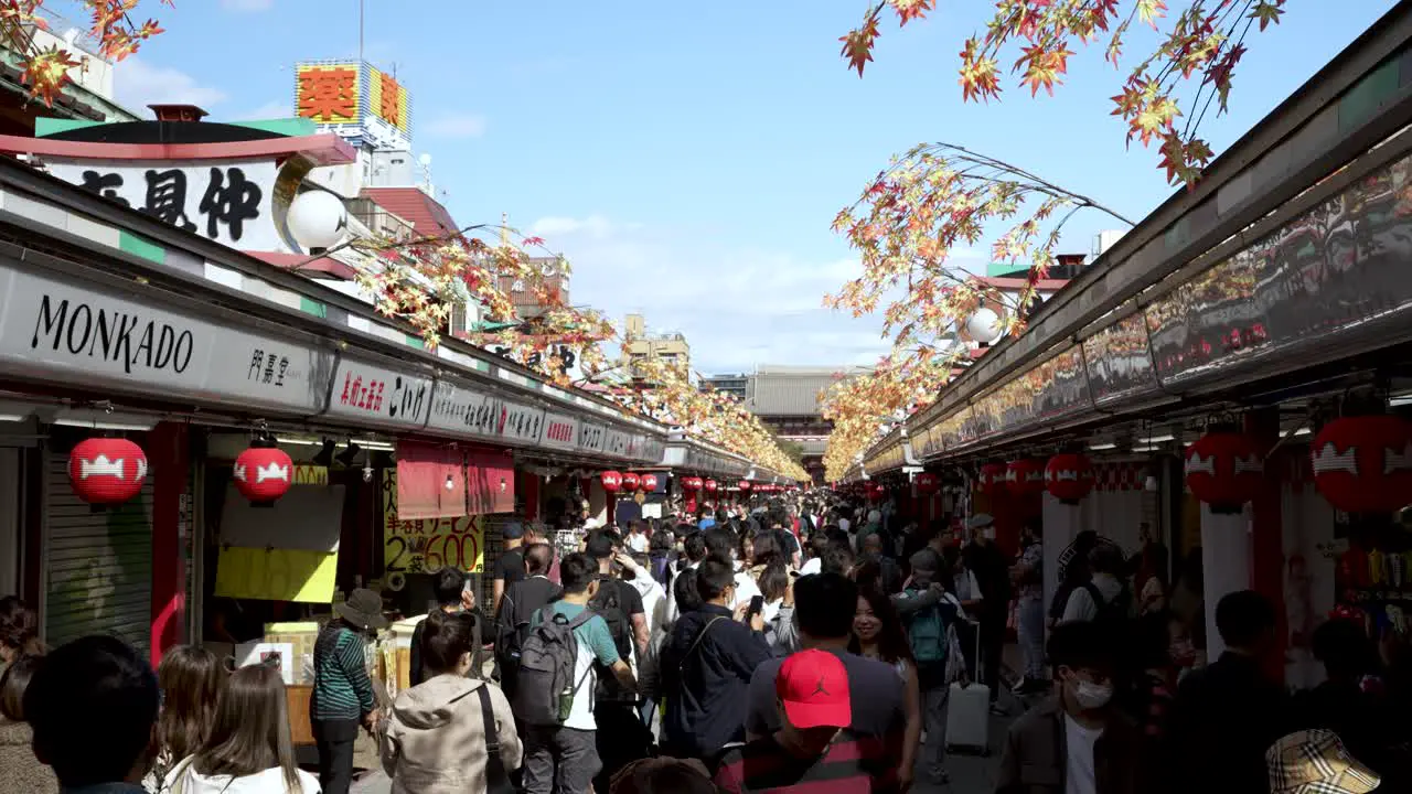 Over Tourism With Crowds Of Tourists Walking Along Nakamise-dori Street