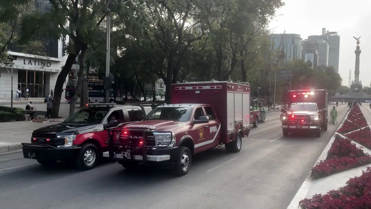 shot of fire trucks from Mexico City parading through the main avenue of the city