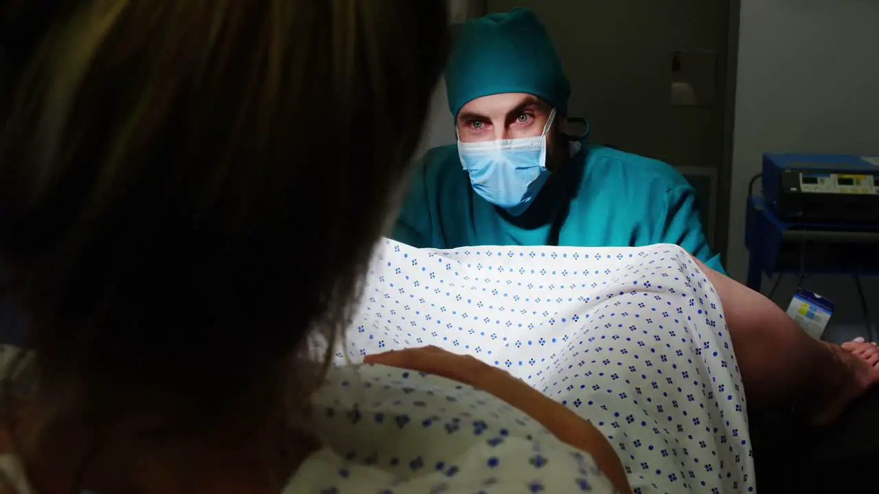 Doctor examining pregnant woman during delivery