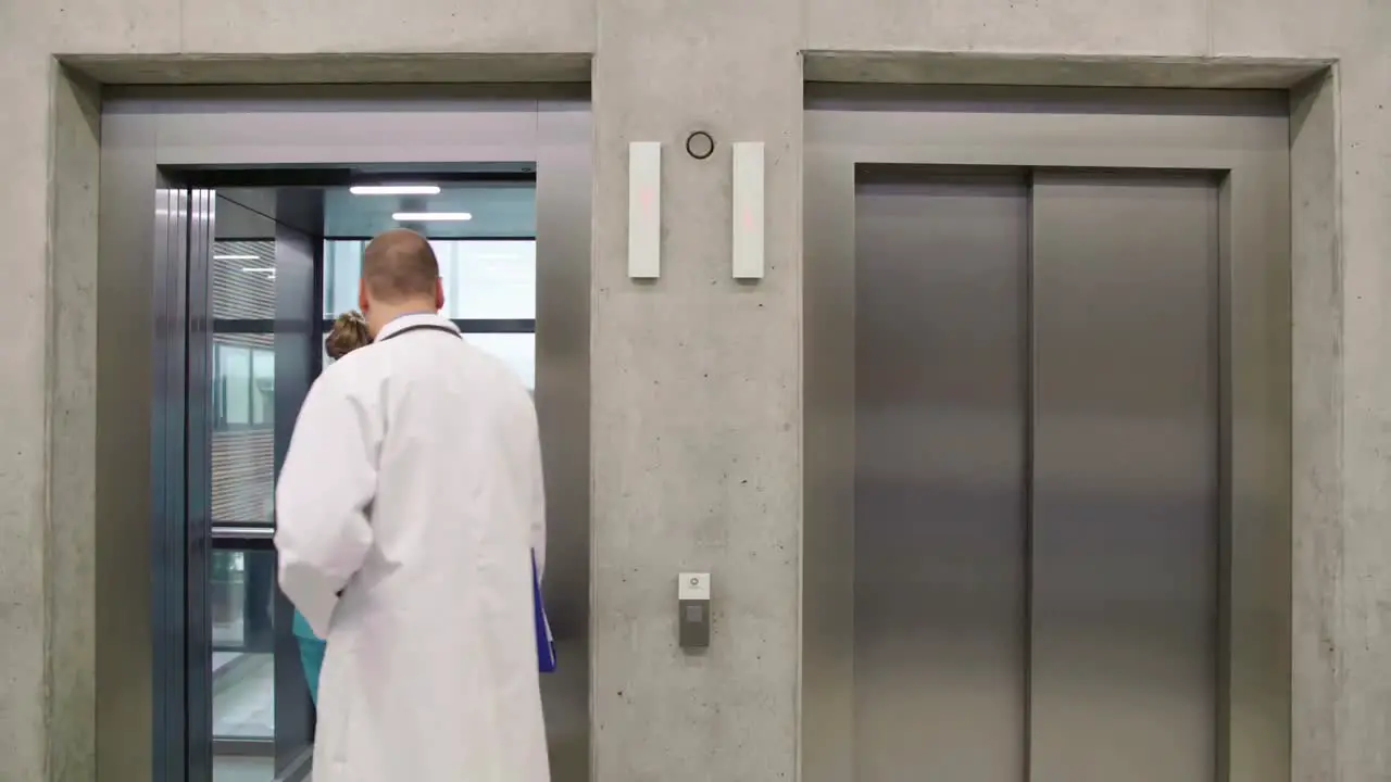 Doctor and nurse interacting with each other and entering in lift