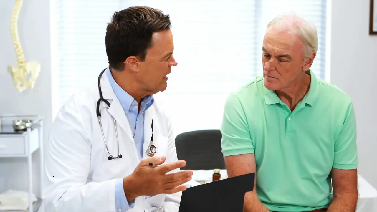 Doctor interacting with senior patient over a report