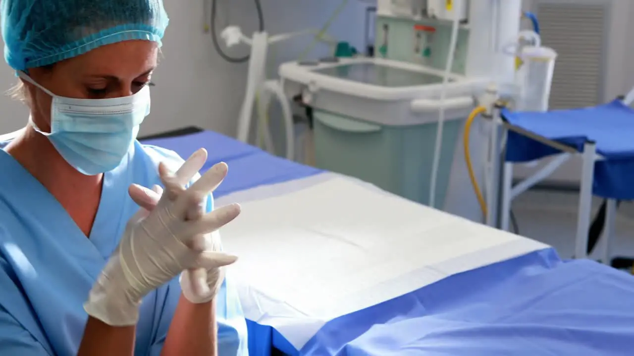 Sad female nurse sitting in operation theater