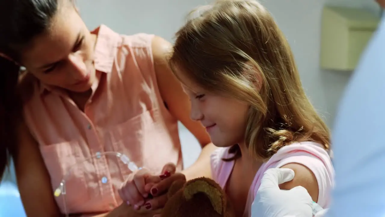 Male doctor giving injection to girl patient 4k