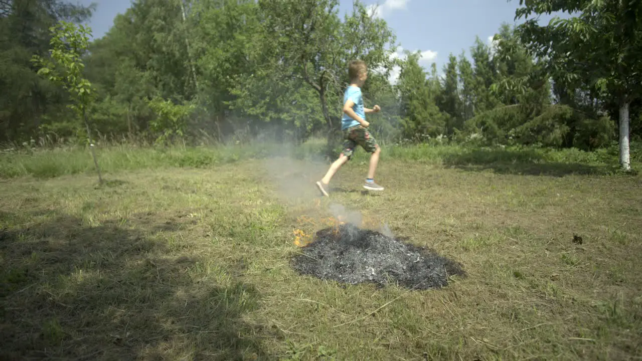 Child lights Bonfire slow motion