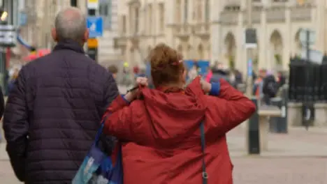 Tracking Shot Following Adult Couple In Street