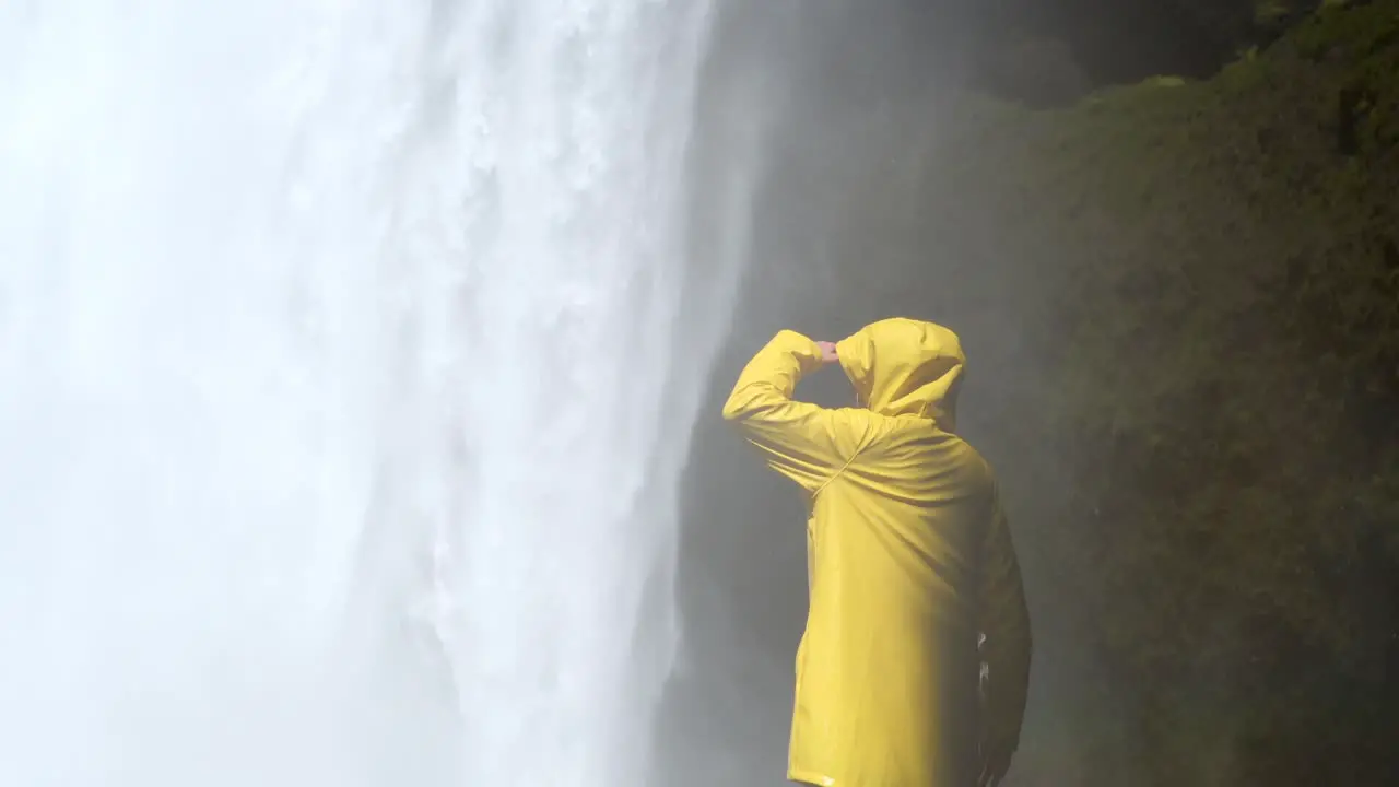 Woman Wearing Yellow Jacket Skógafoss in Iceland 4K