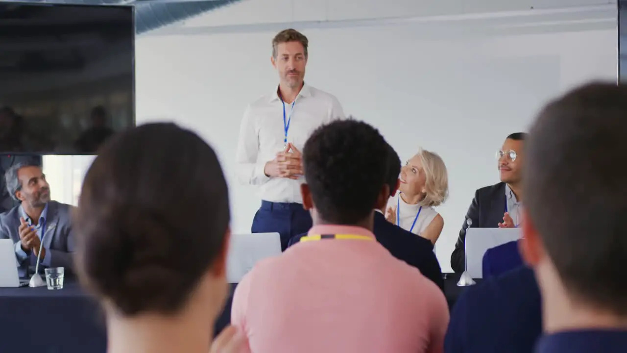 Speaker addressing the audience at a business conference