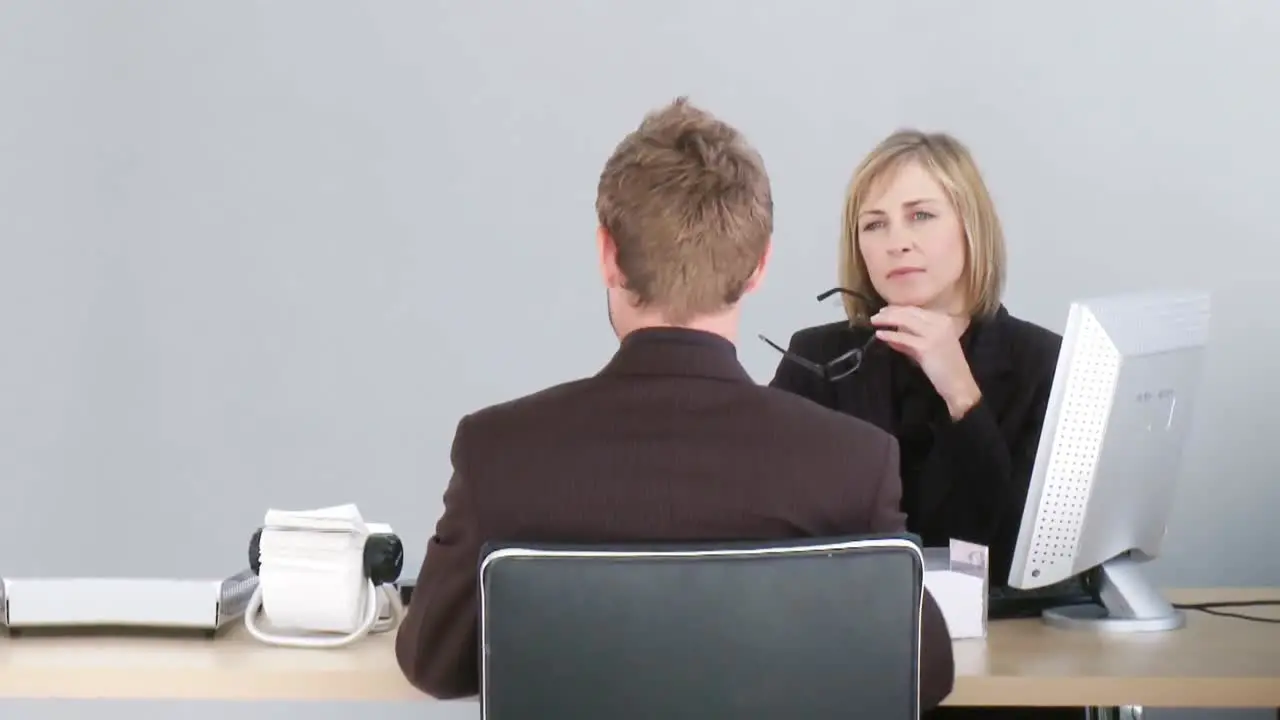 Two associates talking at a desk