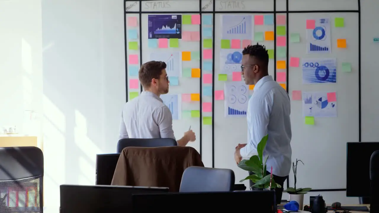 Side view of young cool mixed-race business team planning and working in a modern office 4k