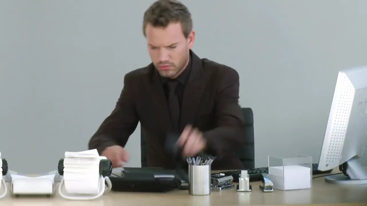 Businessman working on his desk with a phone