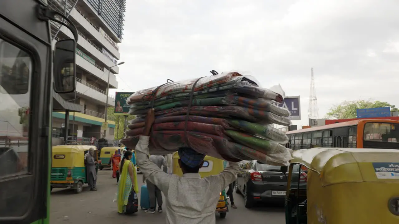 Indian Man Carrying a big bundle on his head Delhi India