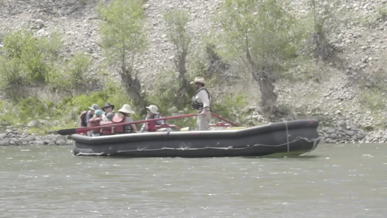 Group of People Floating Down River in Raft