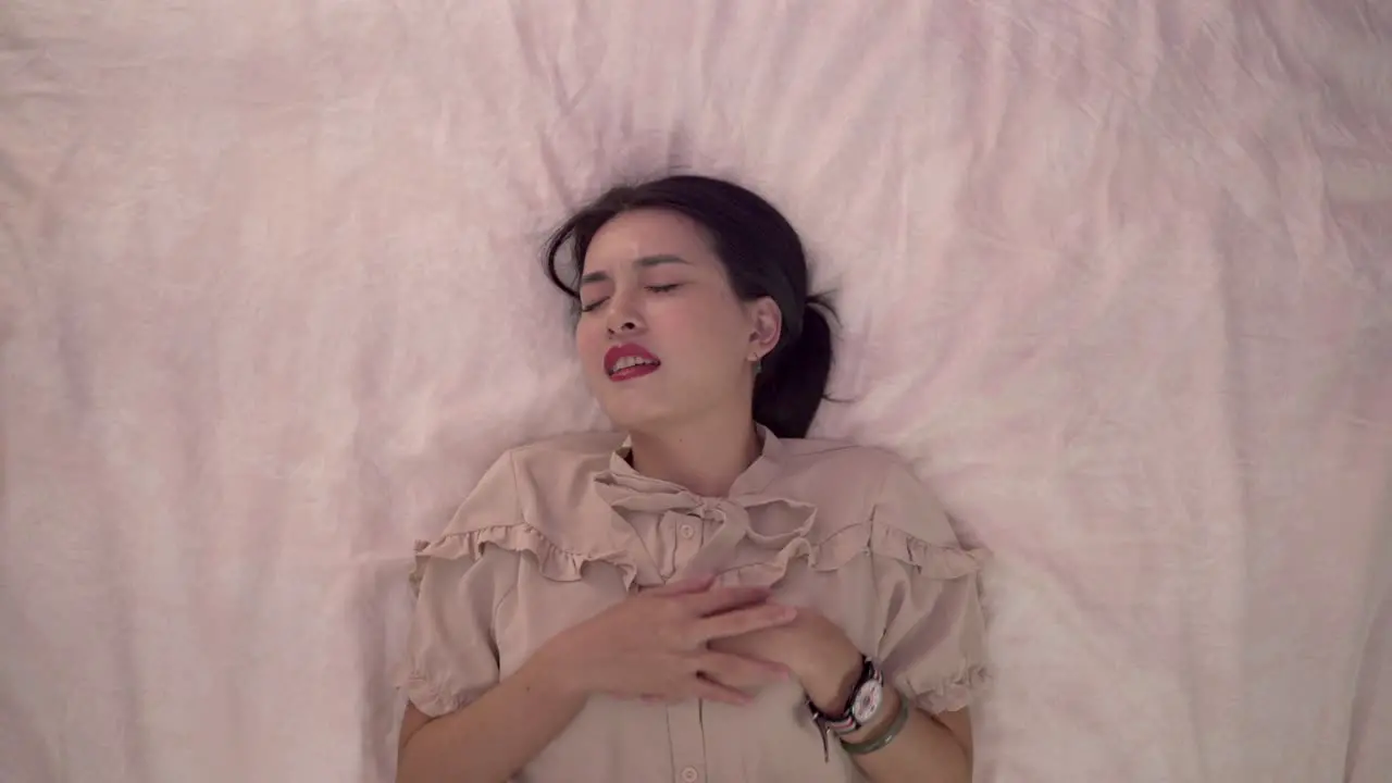 Overhead shot of girl crying on the bed