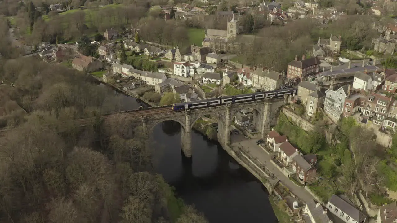 drone shot of train crossing a bridge