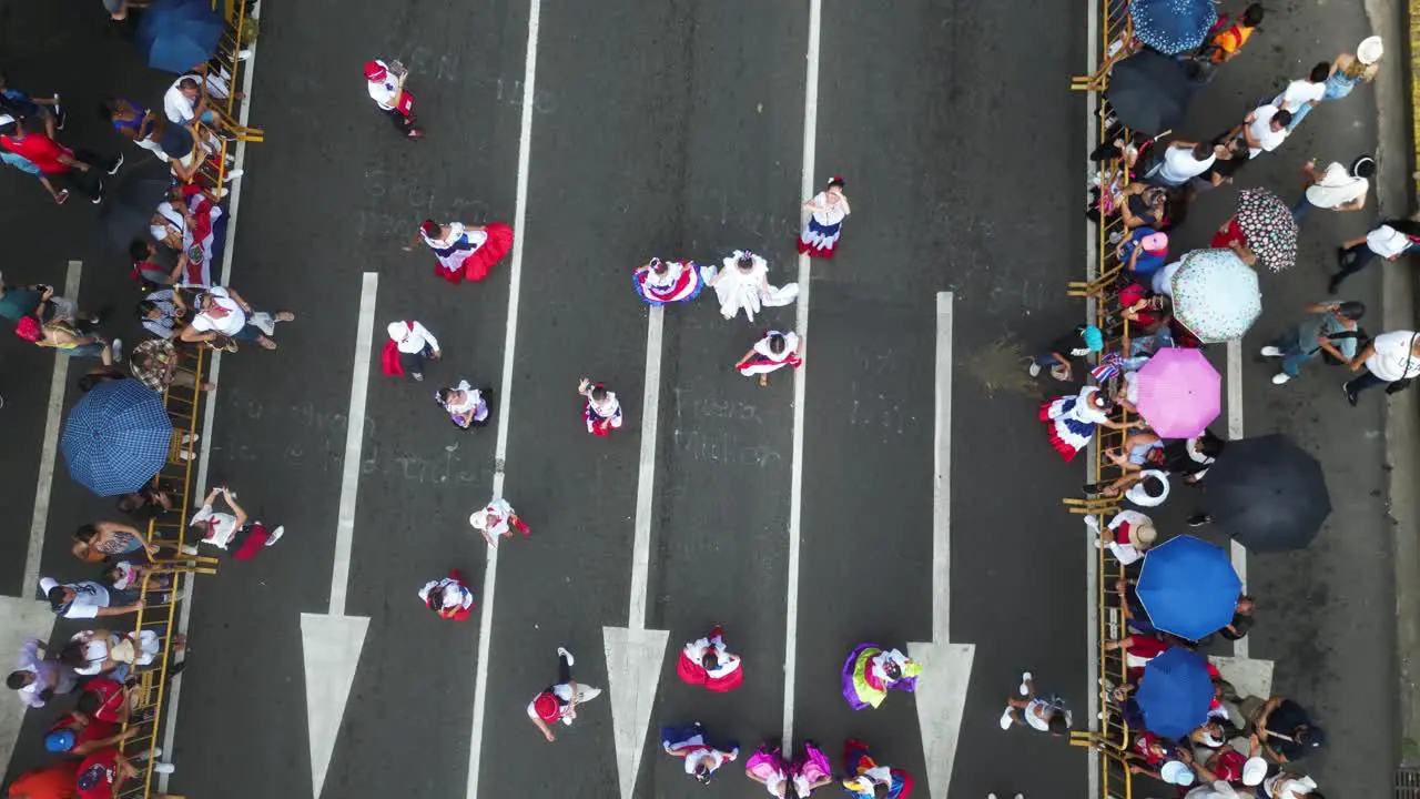 Children in Traditional Costa Rican Clothing Waving at Drone as it Pulls Away