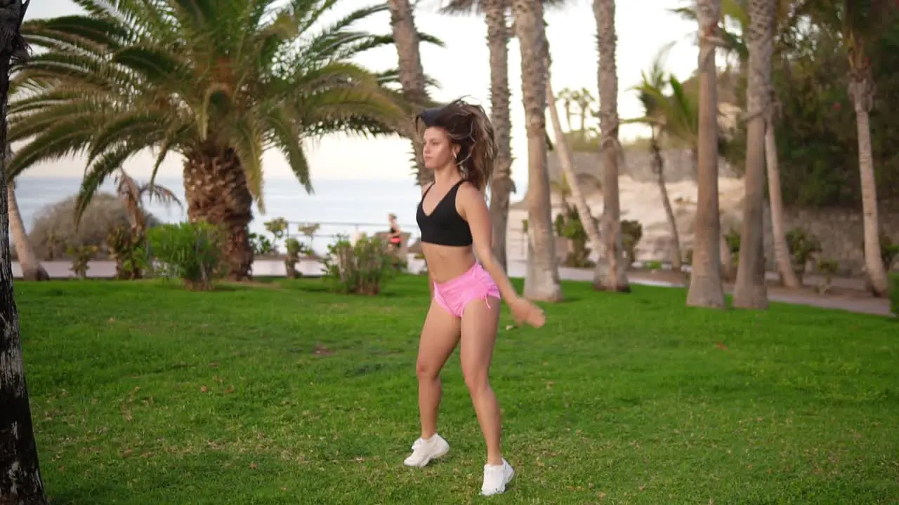 Fitness Long Haired Woman Does Sport Workout In At Tropical Park