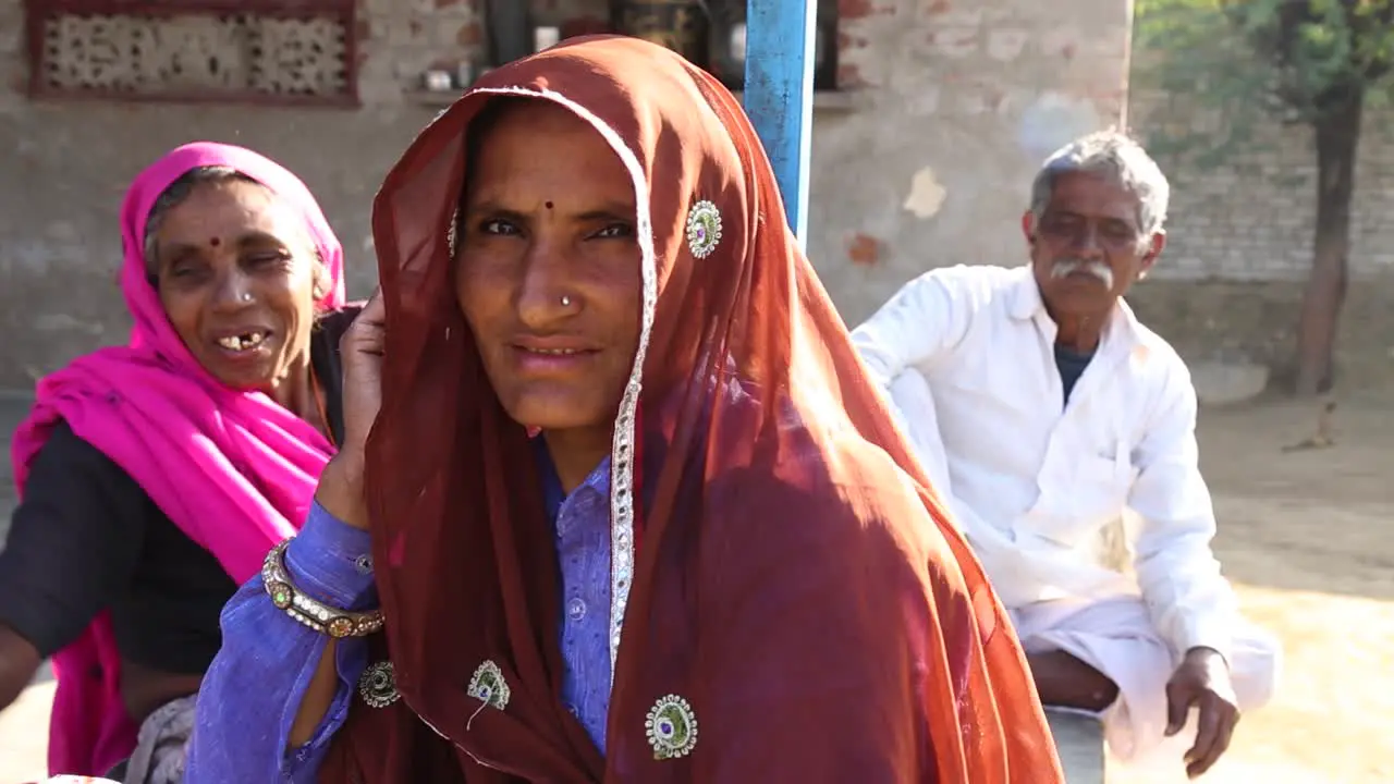 Indian family with women in traditional clothing looking at camera Rajasthan