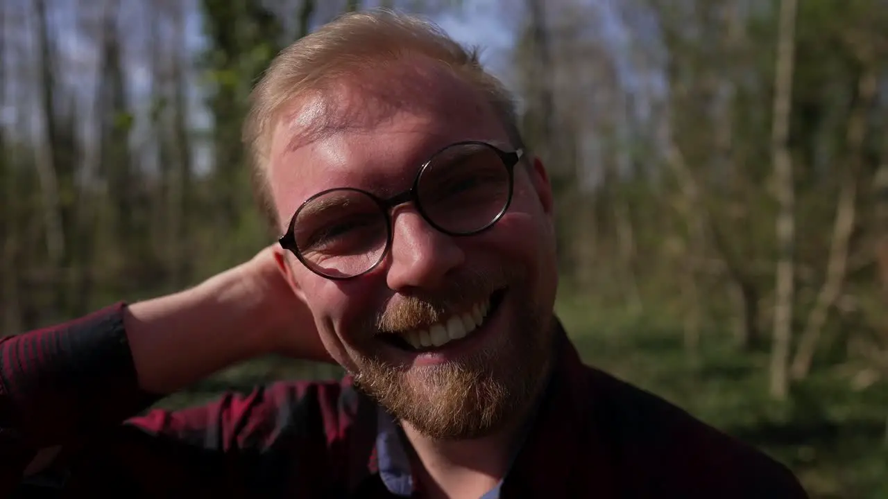 Happy Handsome Young Man Smiles Dolly in Outside in Nature Sunny Day