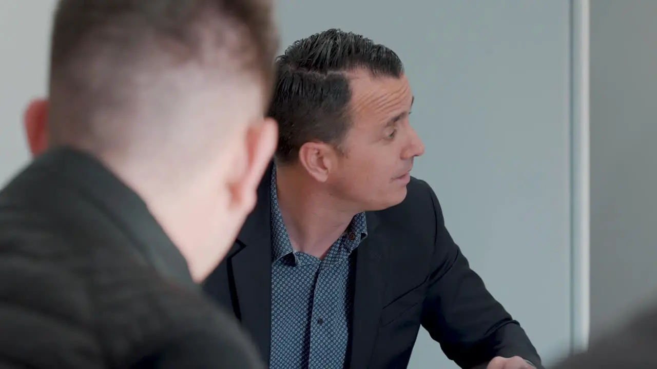 Slow motion shot of a business meeting taking place within a boardroom