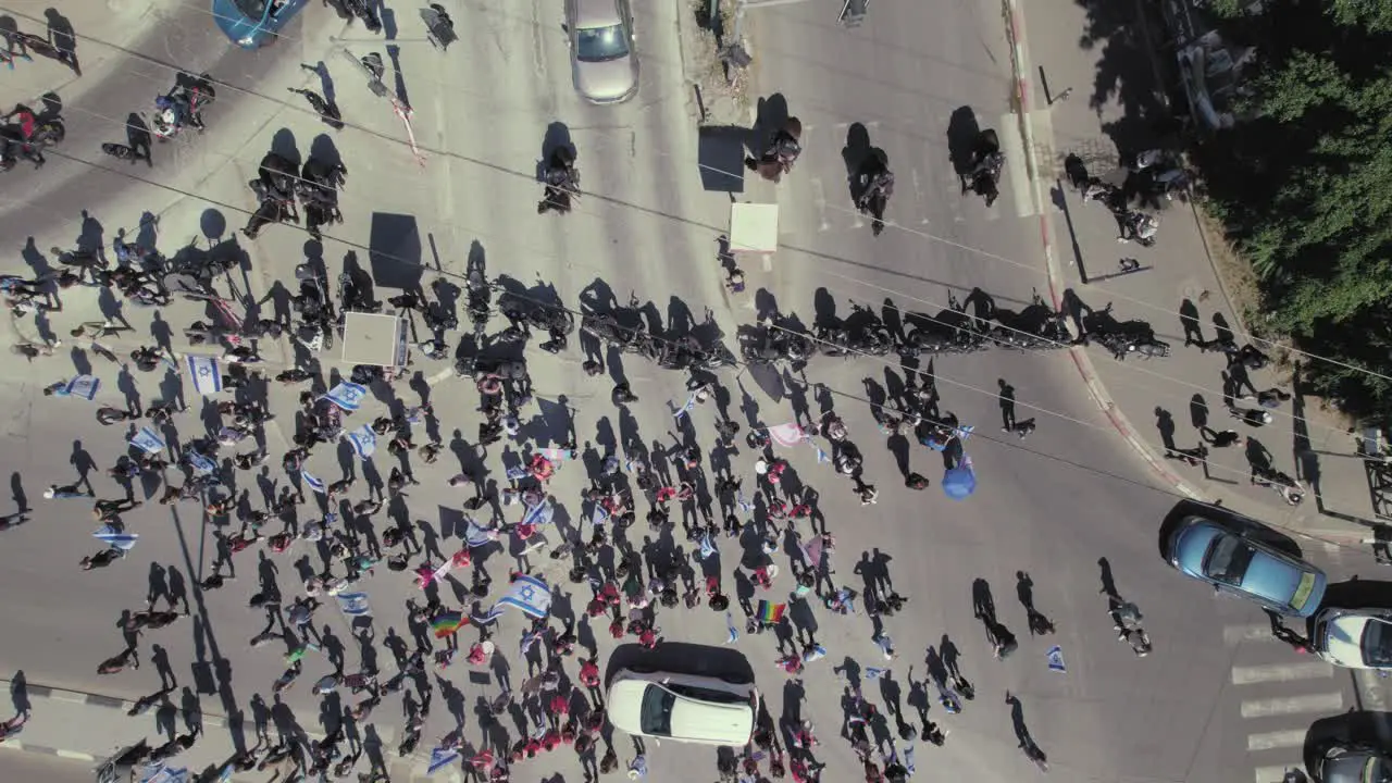 Policemen with horses and motorcycles do not allow Israeli citizens protesting against the government to block roads