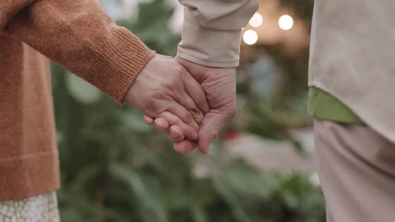 Adult couple holding hands together