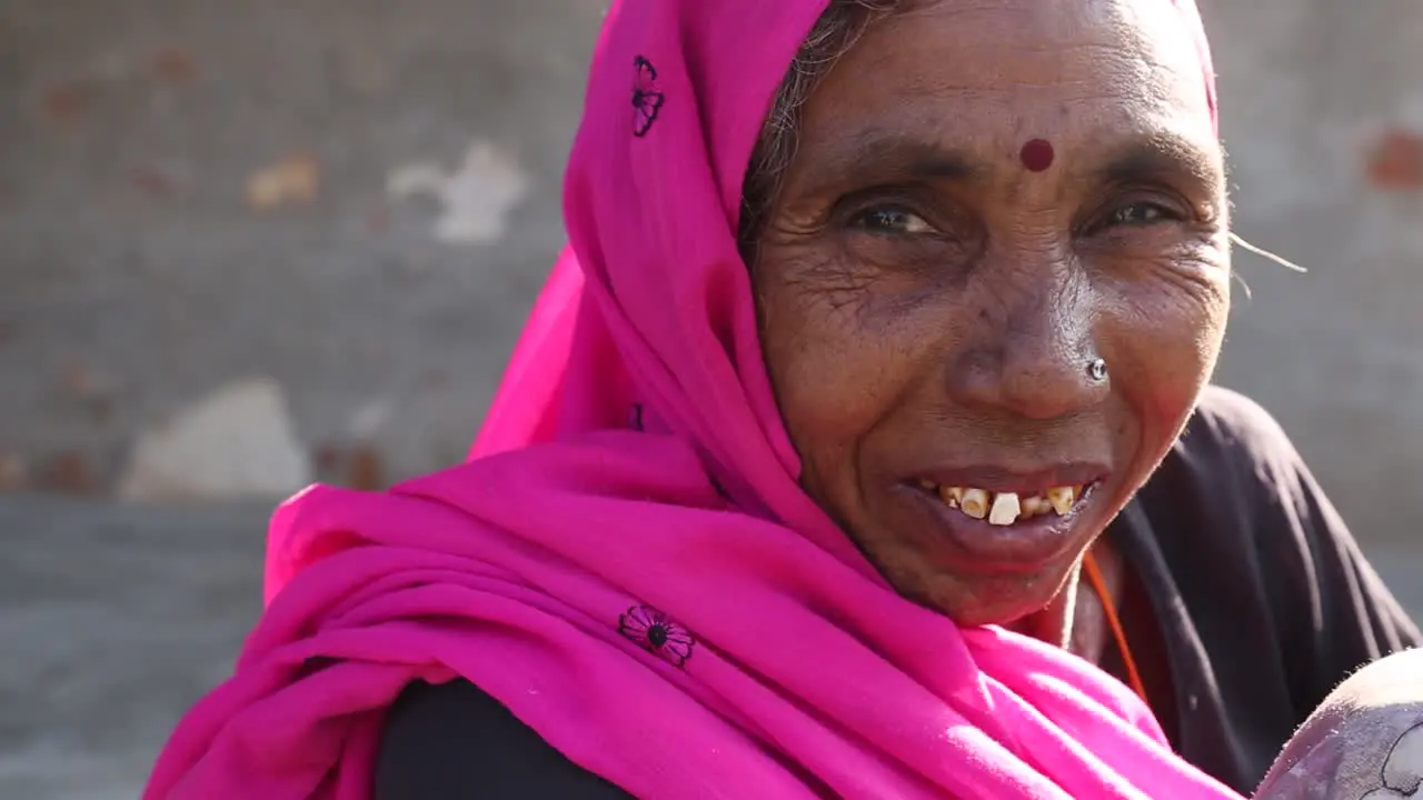 Portrait of elderly Indian woman smiling with crooked teeth